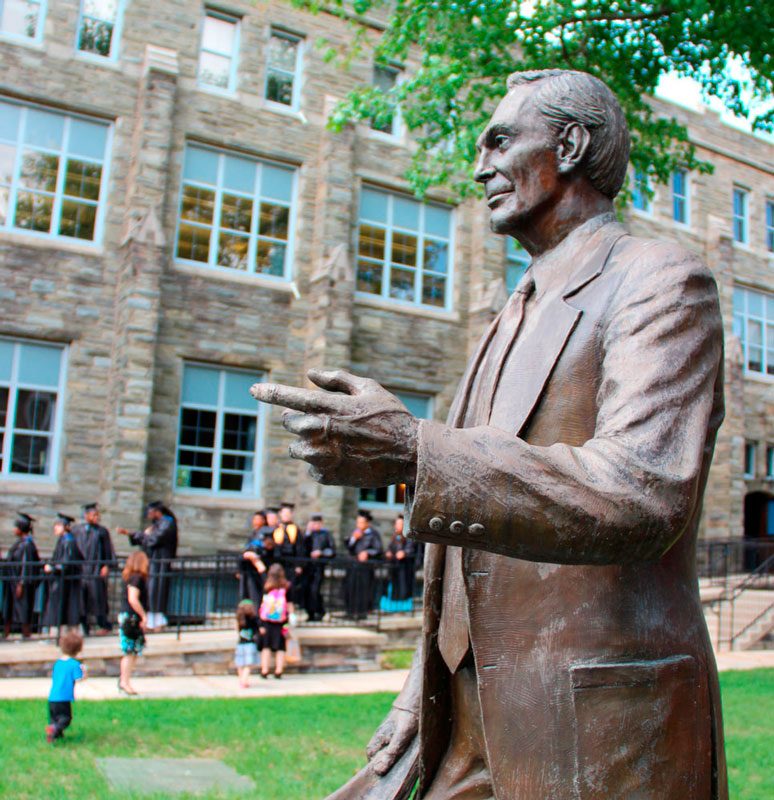 Statue of Walter R. Garrison, founder of P.I.T., on campus during graduation ceremony.